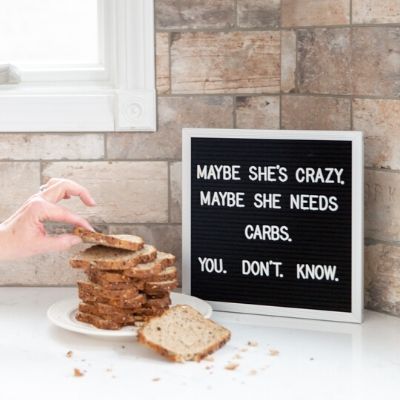 Felt letter board with pile of toast on counter.