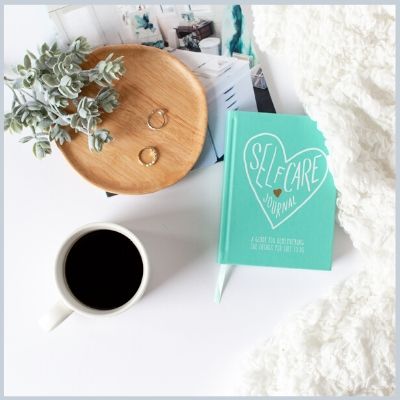 Self-Care Journal and coffee on desktop